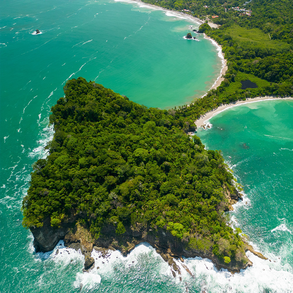 Aerial view of the rainforest-covered peninsula and turquoise beaches of Manuel Antonio National Park, Costa Rica